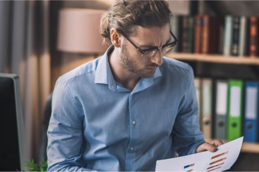 Man looking at graph