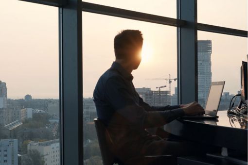 man looking out window 