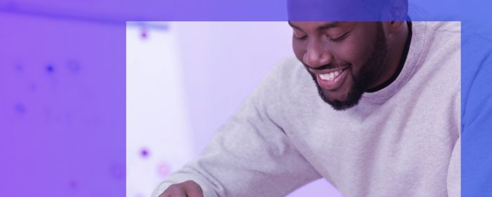 man looking over small wind turbines in office