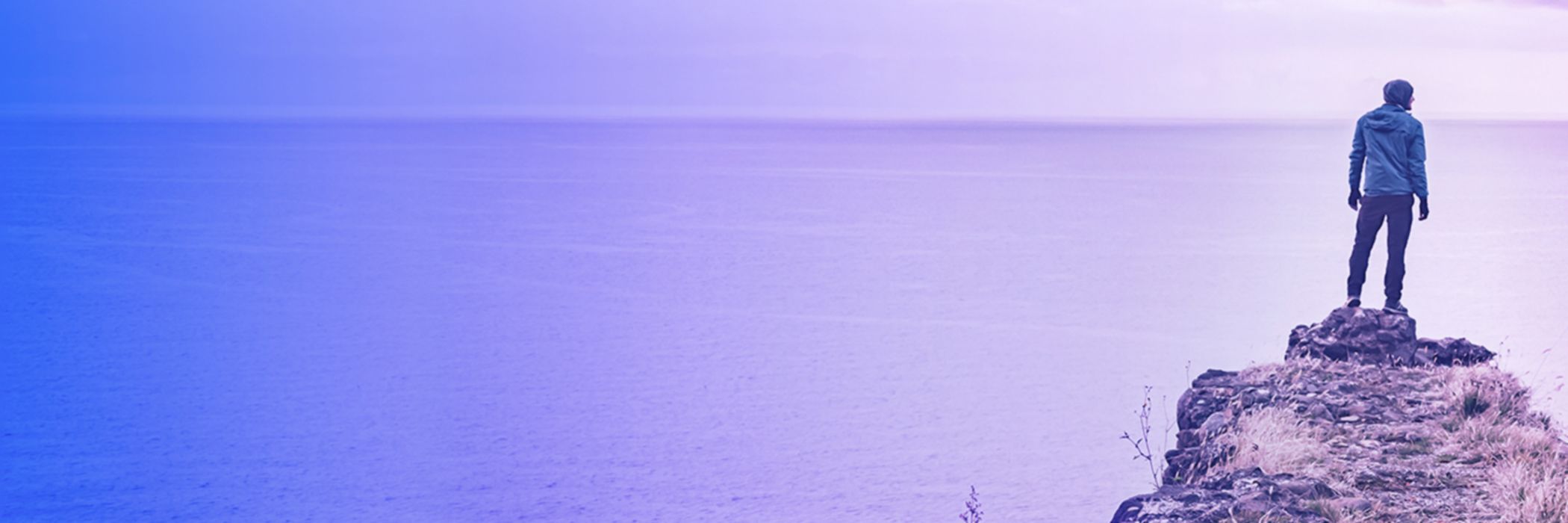 man looking towards ocean banner