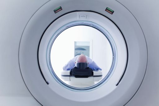 man lying inside a scanning machine