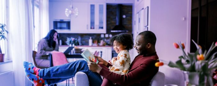 Man reading to his daughter
