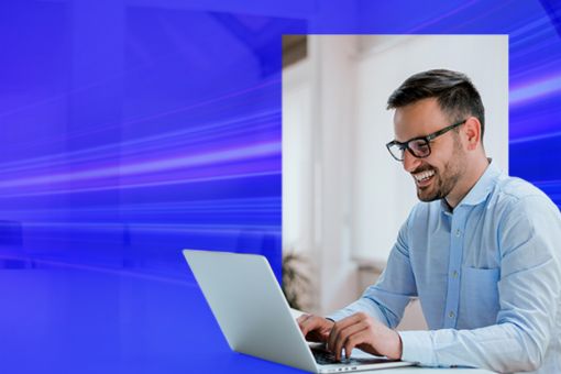 man smiling and working on laptop banner