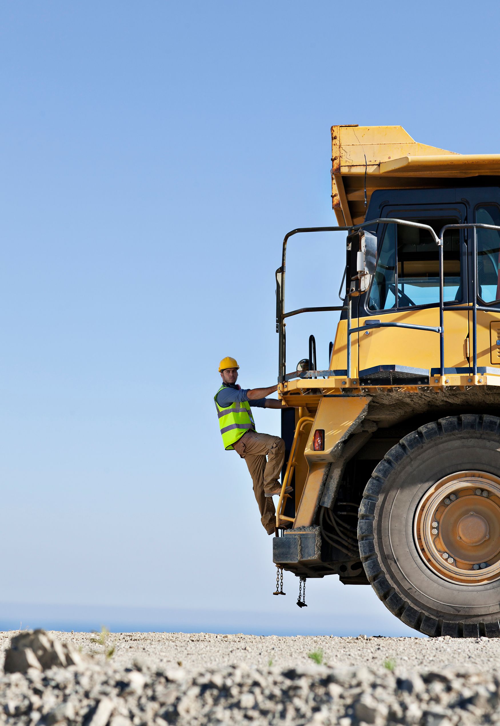 man standing on back of tractor