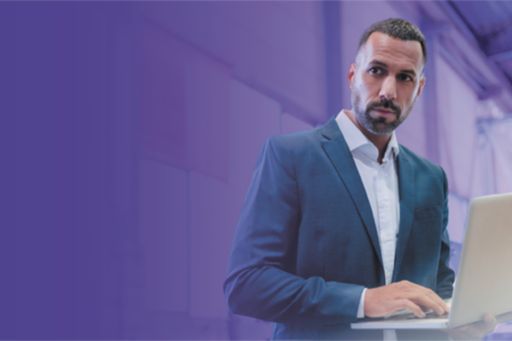 man standing with laptop