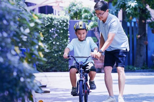 man-teaching-son-to-ride-bicycle