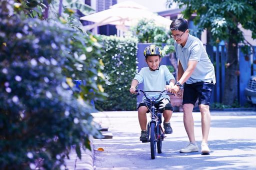 Man teaching his son how to ride a bicycle