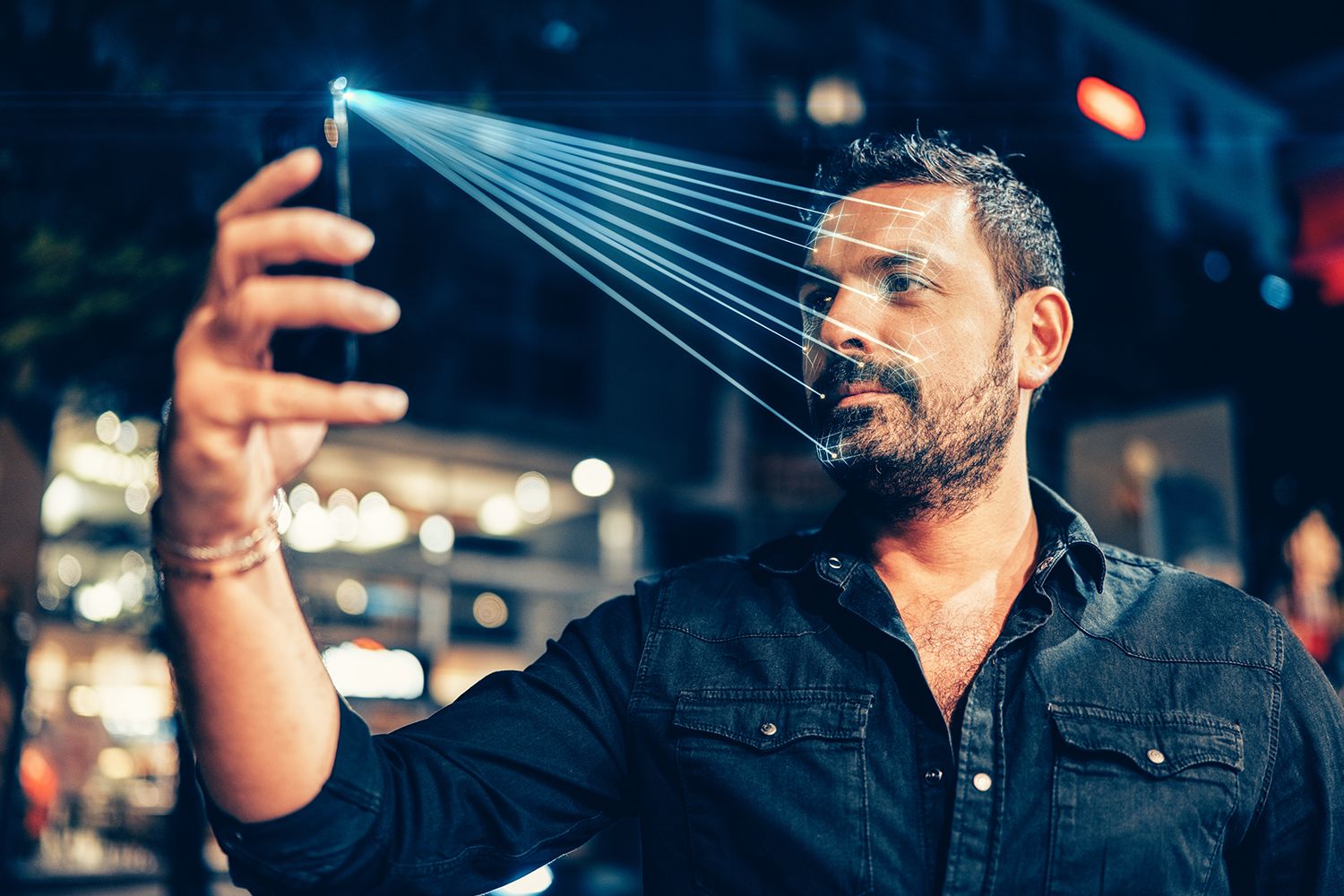 Man using mobile phone for facial recognition.