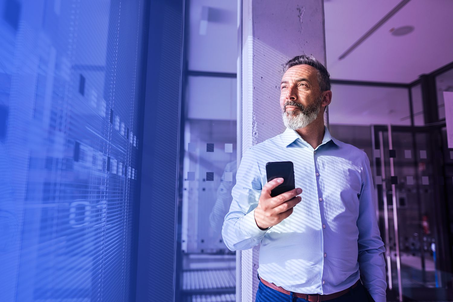 man-with-a-phone-looking-at-the-window