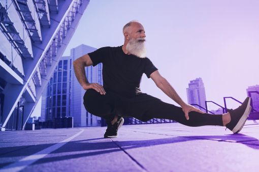older bearded man doing yoga pose