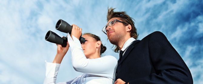 Man and woman looking through binoculars