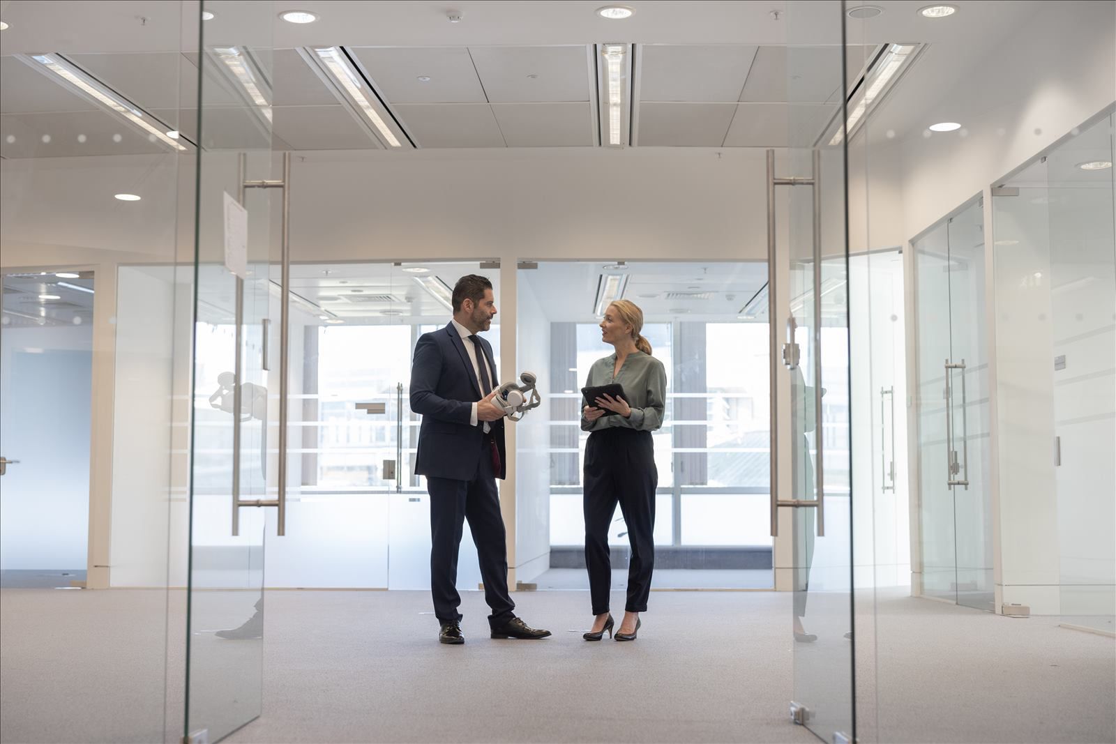 Man Woman Discussing in Hallway