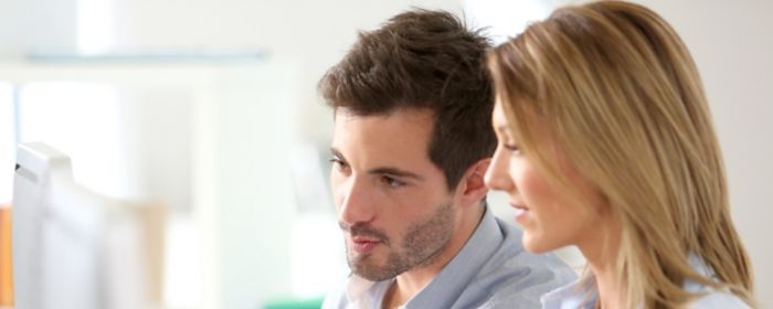 Man woman looking at computer screen
