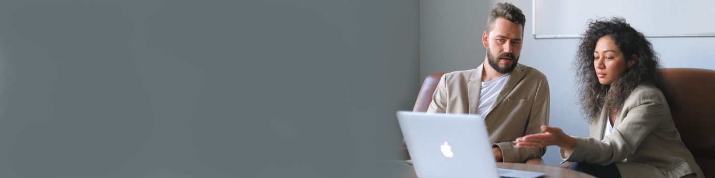Man and woman looking at laptop screen