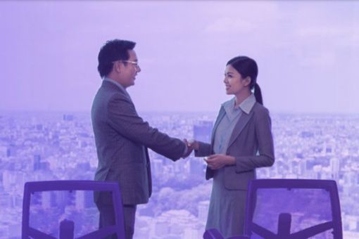 Man Women Shaking Hands in Office