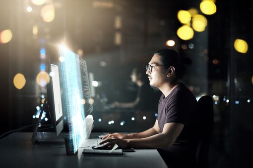 Man working on computer at night