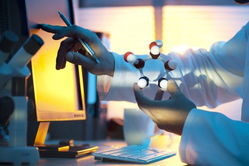 Man working on screen with chemical structure