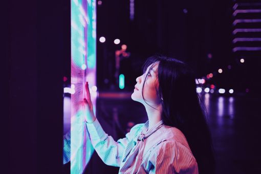 Young woman using touch screen on the street