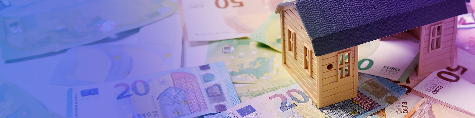 Miniature house stands on banknotes