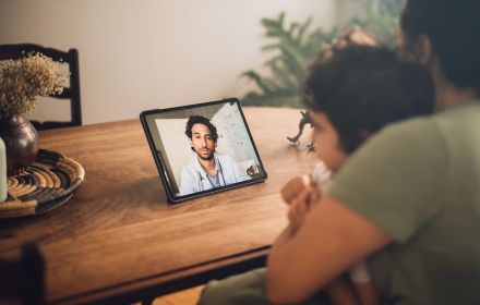 mom and son having a video call with a doctor