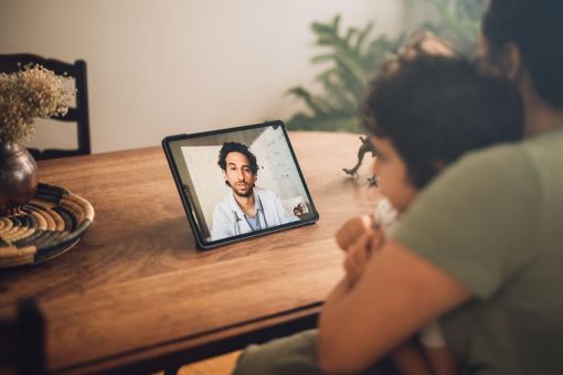 mom and son having a video call with a doctor