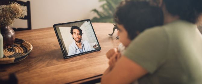 mom and son having a video call with a doctor