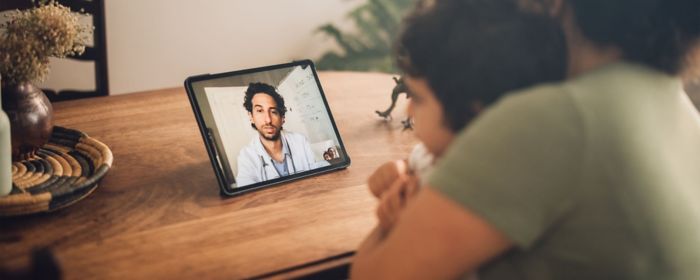 mom and son having a video call with a doctor
