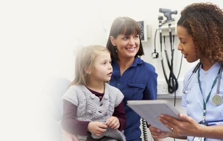 female doctor speaking with mother and daughter