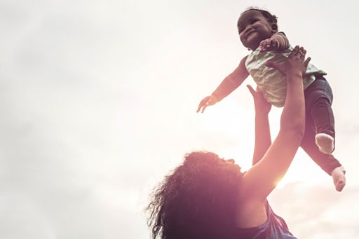 Mother holding up the child