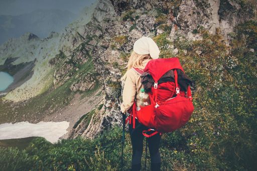 Mountain hiker with red backpack