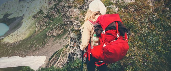 Mountain hiker with red backpack