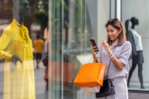 Woman on phone while shopping