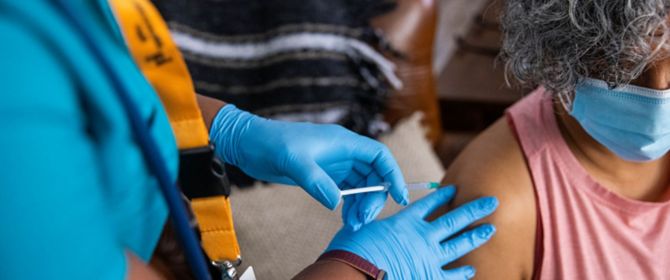 Nurse Giving Covid-19 Vaccine to a Woman