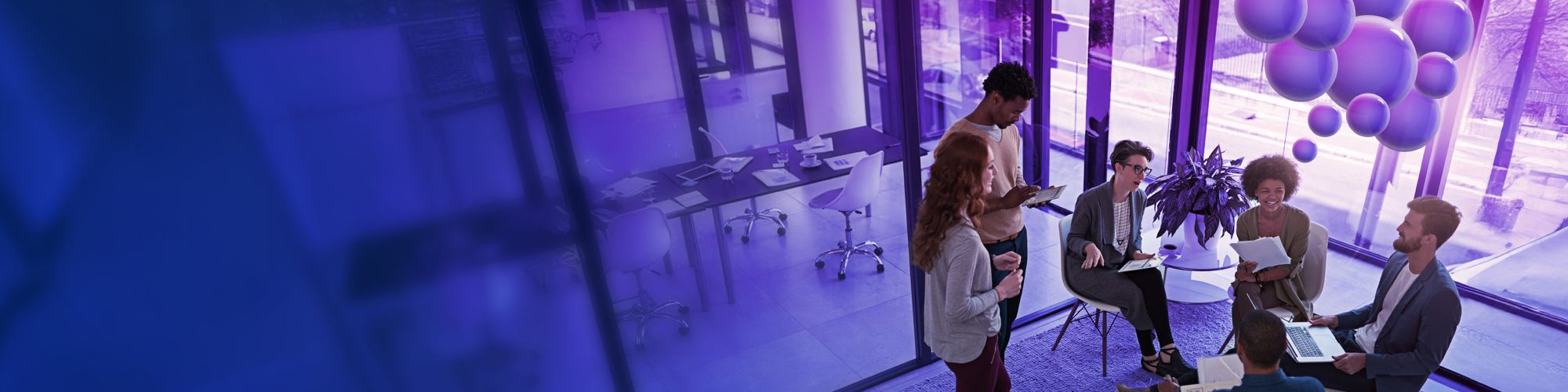 Office workers sitting in a circle in front of purple bubbles