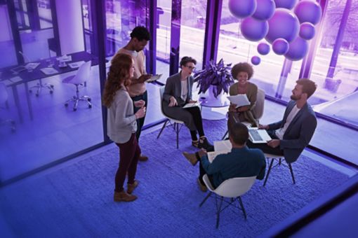 Office workers sitting in a circle in front of purple bubbles