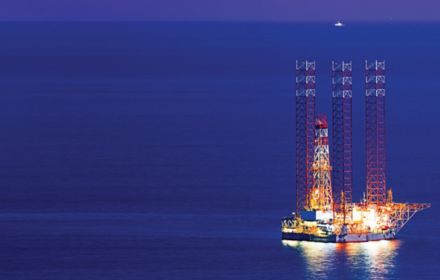 Offshore oil rig at night time