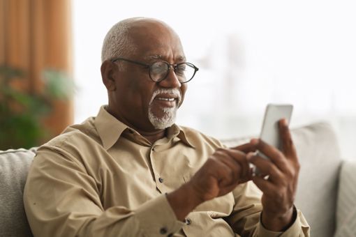 Old man looking at phone screen