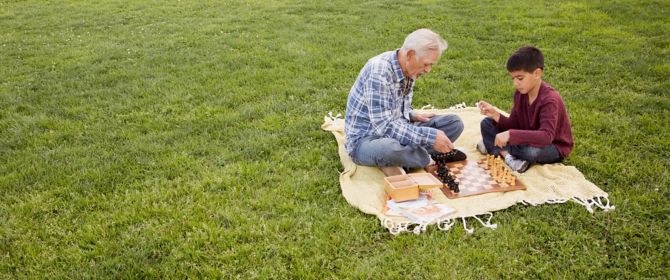 Two people sitting on grass