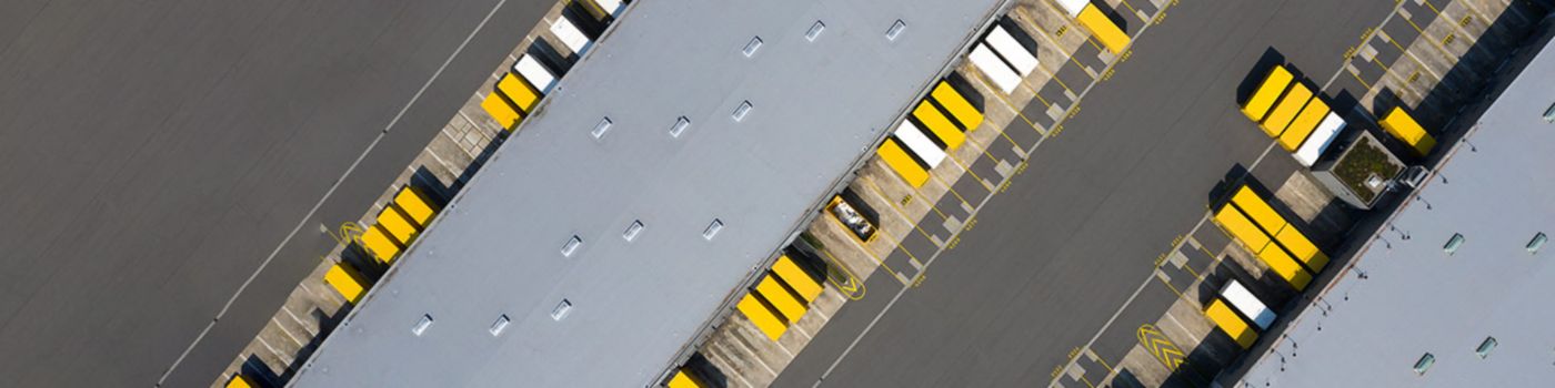 Warehouse hall with yellow trucks