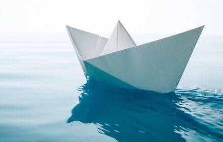 Paper boat floating in water