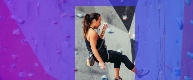 woman climbing wall