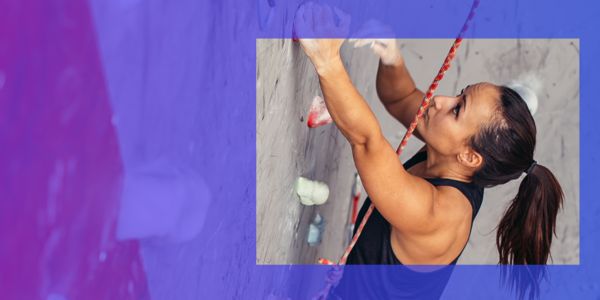 woman climbing wall