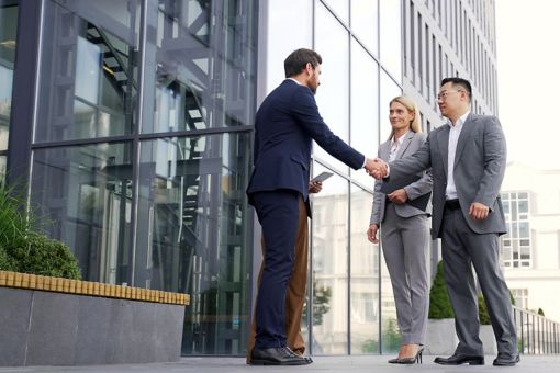 Professionals greeting each other outside building
