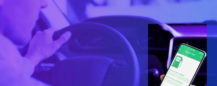 person looking at smartphone screen with charging status of electric car