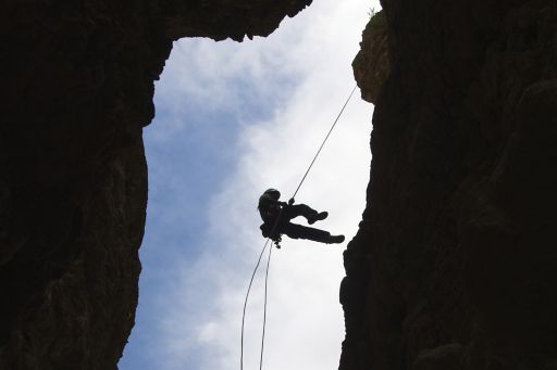 person-repelling-off-cliff