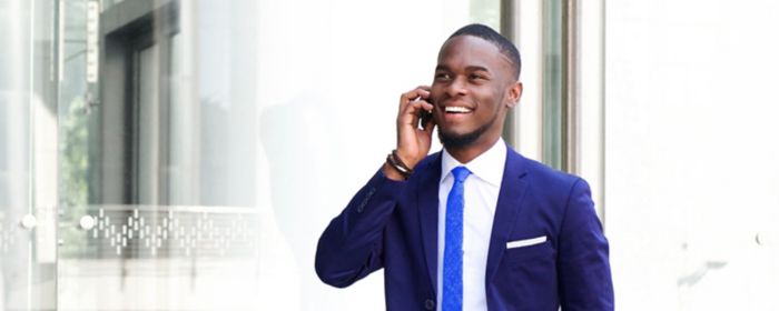 Person walking whilst holding a phone to their ear