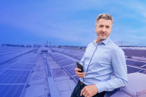 Person standing with a phone with solar panels in the background