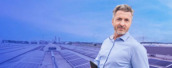 Person standing with a phone with solar panels in the background