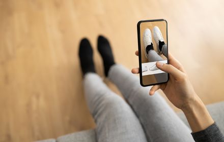 Person using AI app to try shoes
