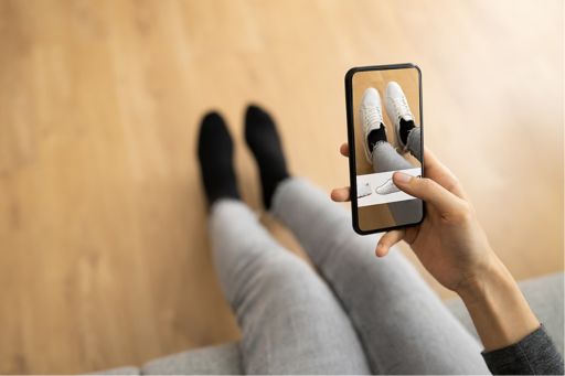 Person using AI app to try shoes
